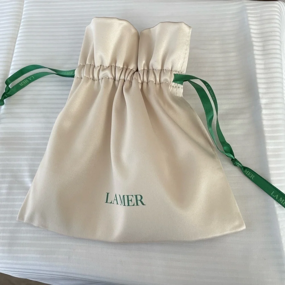 La Mer. Cream Satin Pouch. New, unused.Great for makeup, jewelry, or accessories